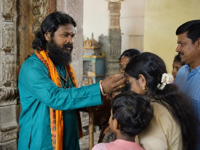 Spiritual leader blessing devotees at the temple